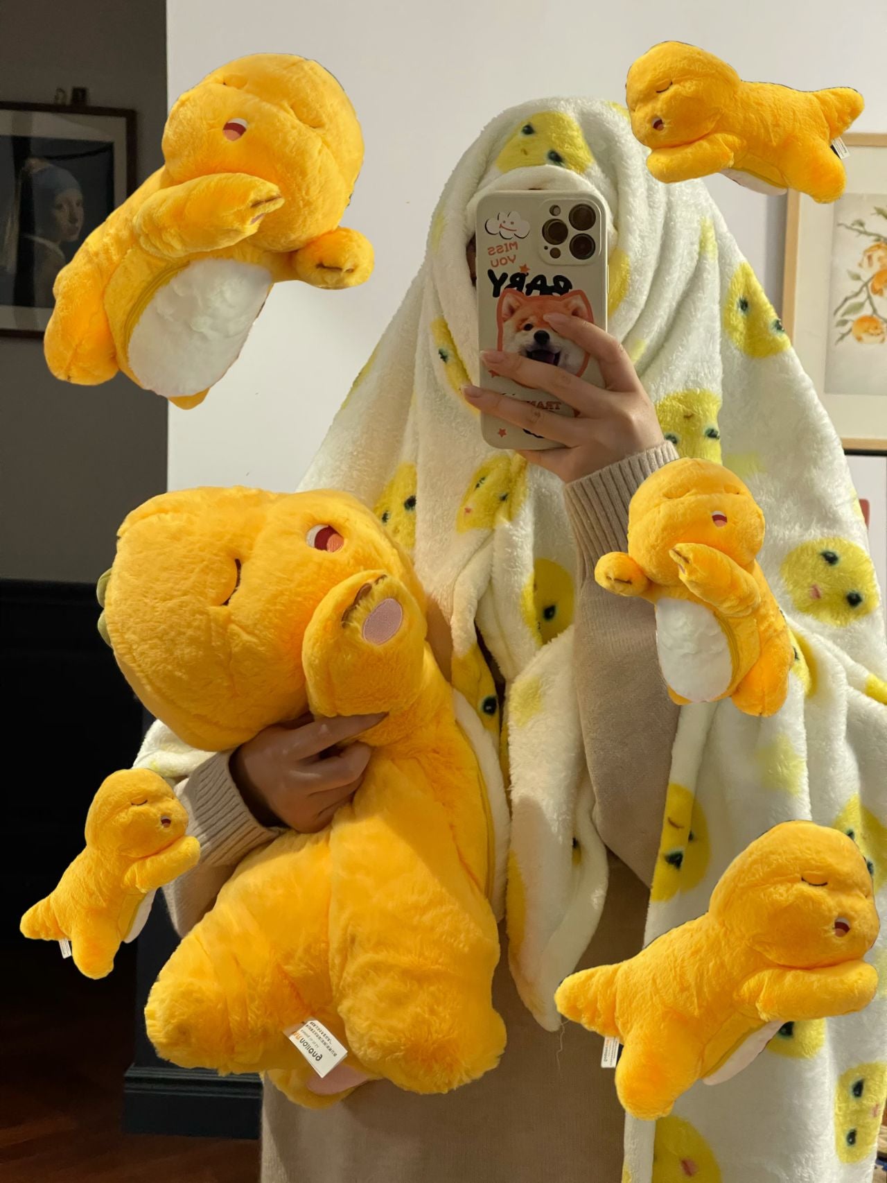 Yellow dinosaur doll with blanket ๐