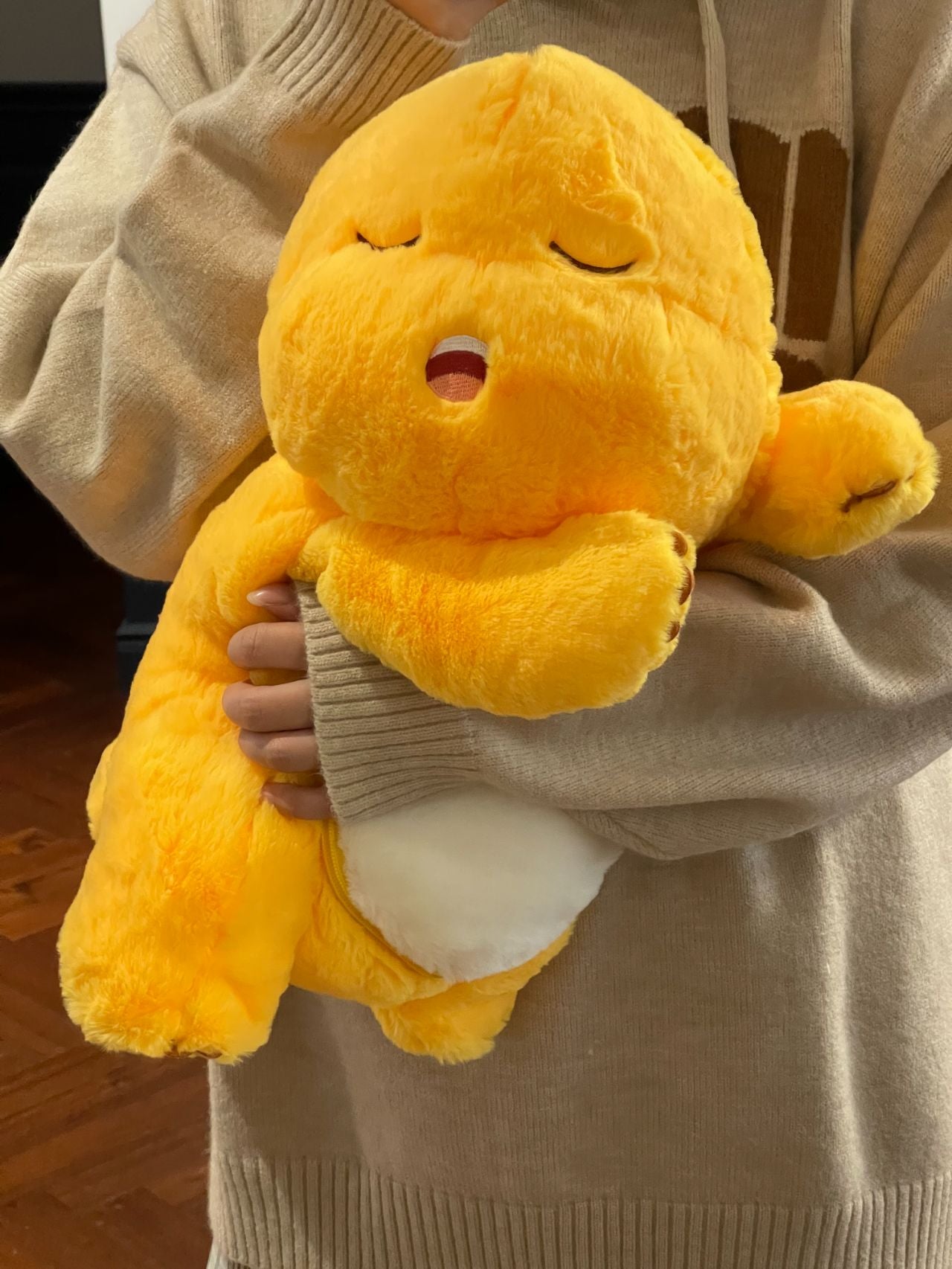 Yellow dinosaur doll with blanket ๐