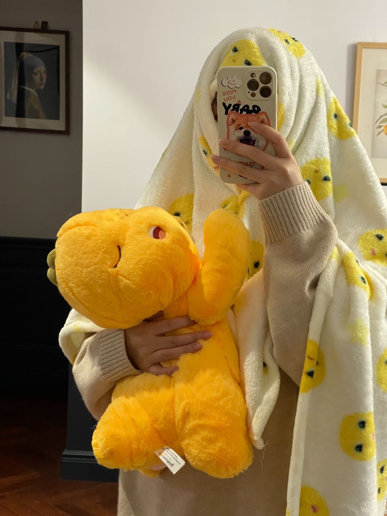 Yellow dinosaur doll with blanket ๐