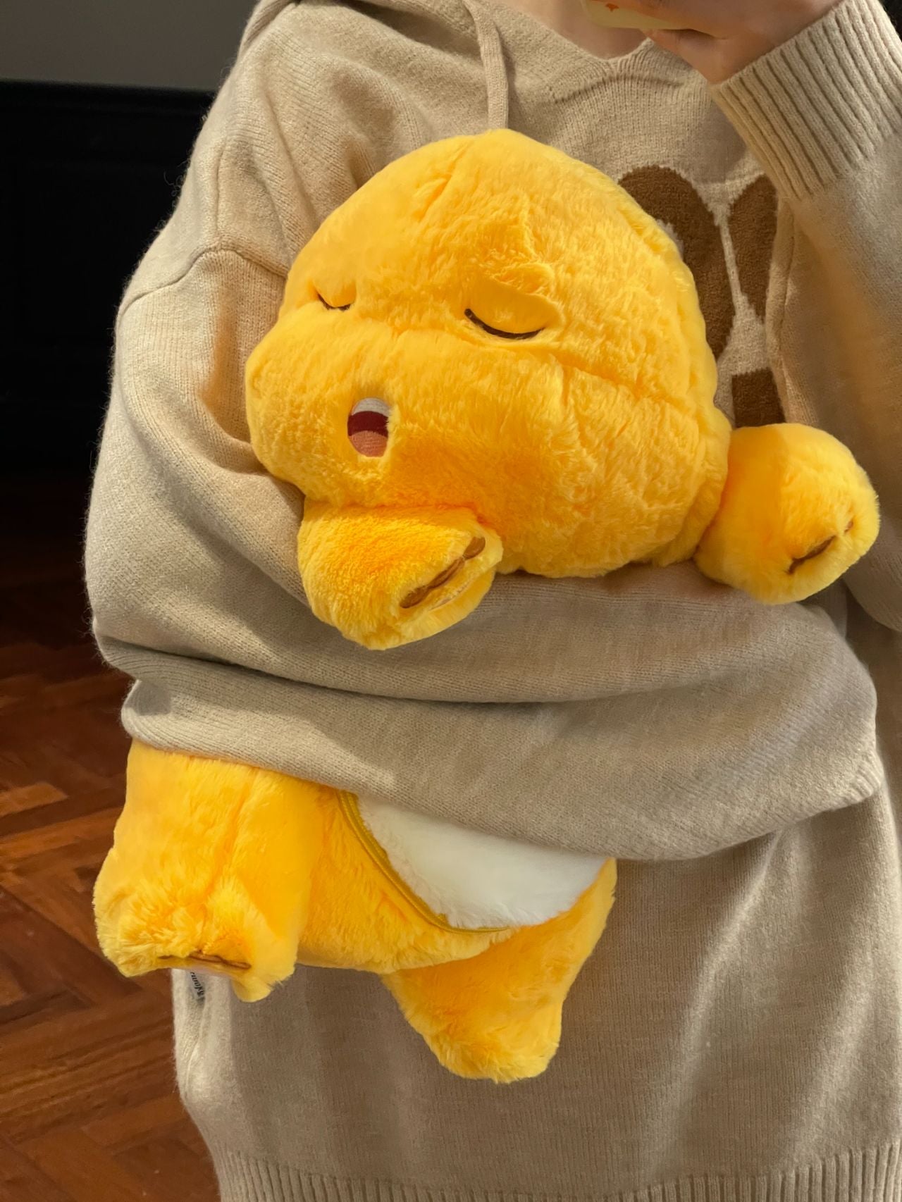 Yellow dinosaur doll with blanket ๐