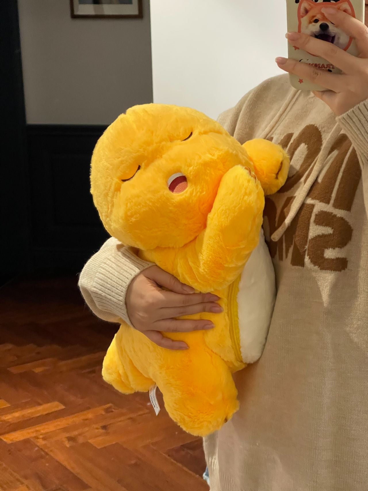 Yellow dinosaur doll with blanket ๐